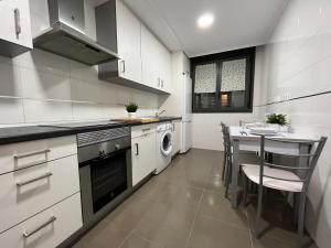 a kitchen with a table and a stove top oven at Apartamento San Vicente de la Sonsierra Confort in San Vicente de la Sonsierra