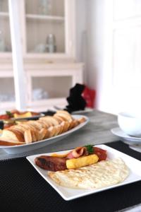 two plates of food on a table with bread at W15 Escape in Ahangama