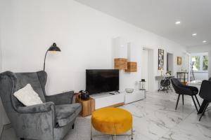 a living room with a television and a chair at Villa Jolanda in Umag