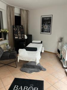 a living room with two beds and a table at Health and Spa by Doro im Hotel am Schwanenweiher in Bad Bertrich
