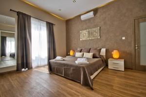 a bedroom with a bed and a large window at Villa Goa - By Luxury Villas Malta in Mellieħa