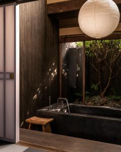 a bathroom with a sink and a large mirror at Maana Kamo in Kyoto