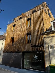 a building with a sign on the side of it at 9WAGRAM Hotel Boutique in Le Mans