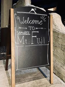 ein Schild an der Tafel, auf dem steht: Willkommen in der Unterkunft in der Unterkunft SAMURISE Mt. Fuji in Fujikawaguchiko