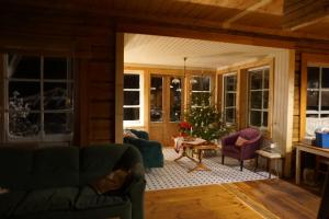 a living room with a christmas tree and chairs at Järve Talu Puhkemaja in Otepää