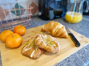 a cutting board with croissants and oranges on a counter at Davis House - 6 Beds, Sleeps up to 7 in Rothwell