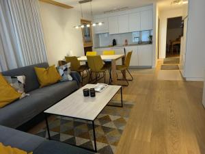 a living room with a couch and a table at Schöne und Moderne Ferienwohnung in Grächen