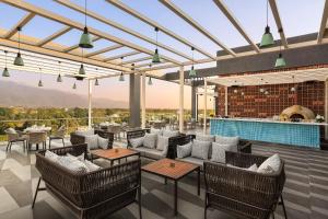 a patio with chairs and tables and a bar at Fortune Walkway Mall, Haldwani - Member ITC's Hotel Group in Haldwāni