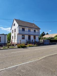 a white house on the side of a road at La maison Blanche - Issenheim in Issenheim