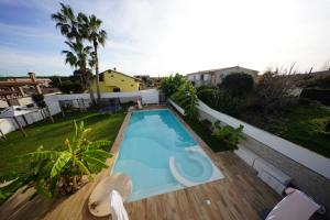 a swimming pool on the roof of a house at Eden Luxury Villa in Focene