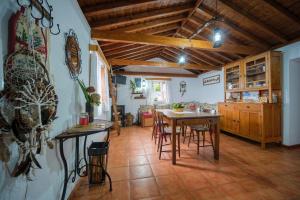 a kitchen and dining room with a table and chairs at Casa do Caramba - The Dream House in São Roque do Pico