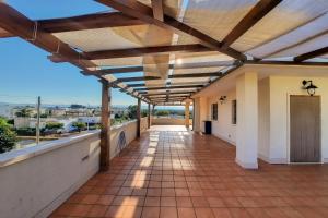 an empty corridor of a building with a balcony at Appartamento Corallo - MyHo Casa in Torre Canne