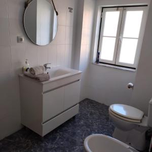 a bathroom with a sink and a toilet and a mirror at ThisisLisbon - RiverView Apartment - 3rd in Lisbon