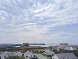a view of a town and a body of water with houses at Pass the Keys Modern 2 Bedroom Apartment with stunning Sea Views in Trearddur