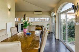 a dining room with a wooden table and a large window at La Haya in Vilacolum