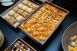 a table topped with trays of pastries and other pastries at The Scholar in Edinburgh