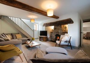 a living room with a couch and a fireplace at Hafod Gau in Cemmaes