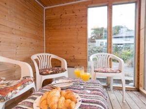 a dining room with a table with bread and orange juice at Pass the Keys Comfortable Stone Built Cottage in Menai Bridge in Menai Bridge