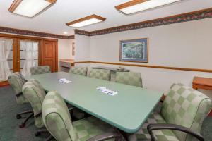 a conference room with a green table and chairs at Baymont by Wyndham Decatur in Decatur