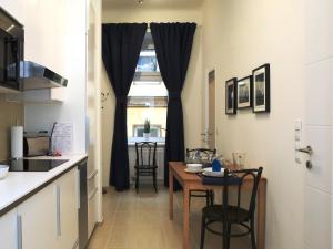 eine Küche mit einem Tisch und einem Esszimmer in der Unterkunft Flatprovider Comfort Eduard Apartment - contactless check in in Wien