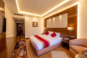 a hotel room with a bed and a couch at The Malla Hotel in Kathmandu