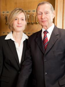 a man and a woman in suits posing for a picture at City Hotel in Delmenhorst