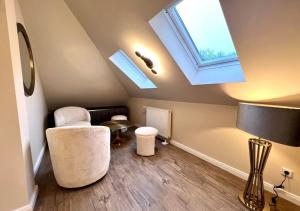 a attic room with a skylight and a table and chairs at Hotel Resort Märkisches Meer in Diensdorf-Radlow