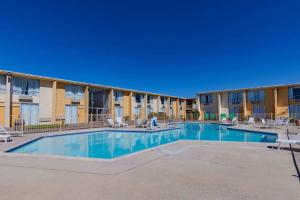 a swimming pool in front of a building at Days Inn by Wyndham Del Rio in Del Rio