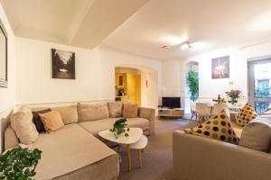 a living room with a couch and a table at Stay Thames River in London