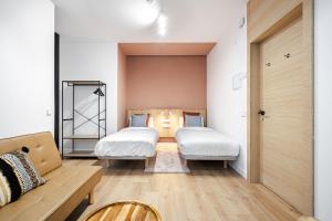 Łóżko lub łóżka w pokoju w obiekcie Vallecas Suites by Olala Homes