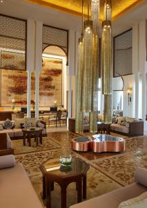 a lobby with couches and tables and chandeliers at Banyan Tree Tamouda Bay in Fnidek
