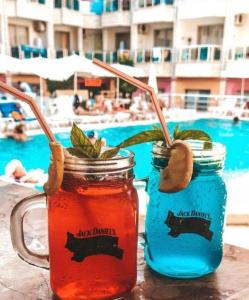 two mason jars filled with drinks next to a pool at Mr Crane Hotel in Kemer