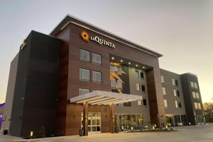 a building with a sun sign on top of it at La Quinta Inn & Suites by Wyndham Galt Lodi North in Galt