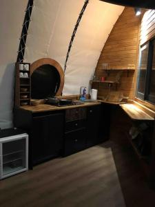 an attic kitchen with a sink and a stove at Cennetin kalbinde size ait bir Kabuk. in Koycegiz