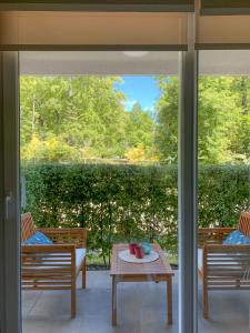 a screened porch with a table and two chairs at Departamento Pucón in Pucón +9 photos