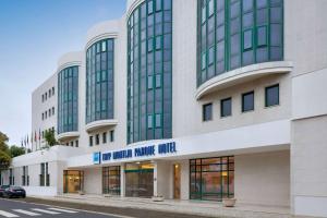 a large building with a sign on the front of it at TRYP by Wyndham Montijo Parque Hotel in Montijo