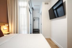 Telewizja i/lub zestaw kina domowego w obiekcie Vallecas Suites by Olala Homes