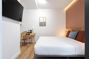 Łóżko lub łóżka w pokoju w obiekcie Vallecas Suites by Olala Homes