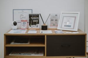 a wooden desk with items on top of it at Maravigghia Palermo Rooms in Palermo