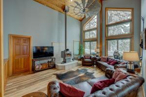 a living room with a leather couch and a tv at Heaven by the Lake in Truckee