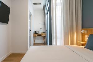 Łóżko lub łóżka w pokoju w obiekcie Vallecas Suites by Olala Homes
