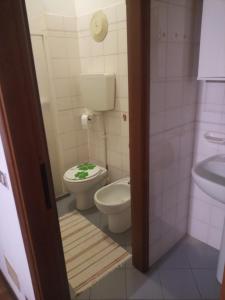 a bathroom with a toilet and a sink at Mazzini in Forlì