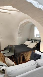 Ένα ή περισσότερα κρεβάτια σε δωμάτιο στο Trulli Piazzetta Pagano