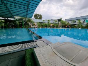 a large swimming pool in front of a building at STAY SWEET in Phnom Penh