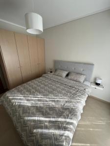 a bedroom with a large bed in a room at SilverLine Comfort Apartment in Thessaloniki