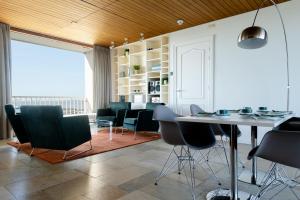 a dining room with chairs and a table and a window at Hotel de Milliano in Breskens