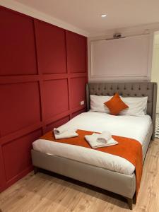 a bedroom with a bed with red walls at St Moscow Suites Taksim in Istanbul