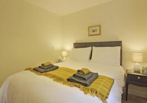 a bedroom with a bed with two towels on it at The Annexe in Snape