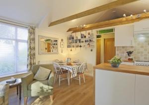 a kitchen and living room with a table and chairs at The Annexe in Snape