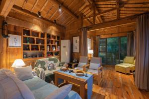 a living room with a couch and chairs in a room at Mild Spring Boutique Hotel in Huangshan